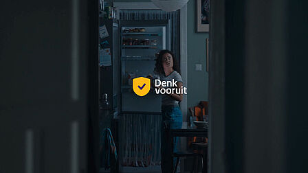 De persoon staat voor een open koelkast waarvan de elektriciteit niet werkt. Dezelfde persoon kijkt naar een lamp die het niet doet, omdat de elektriciteit is uitgevallen. 